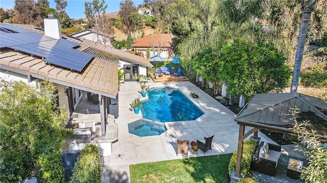 view of pool featuring a patio area and an in ground hot tub