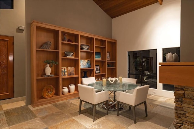 dining room with wood ceiling and high vaulted ceiling