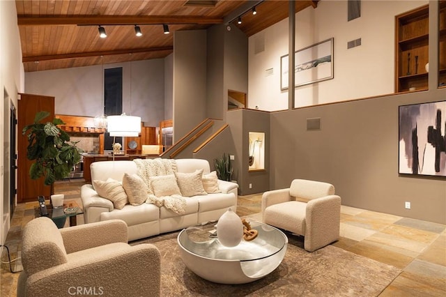 living room featuring beam ceiling, wooden ceiling, high vaulted ceiling, and track lighting