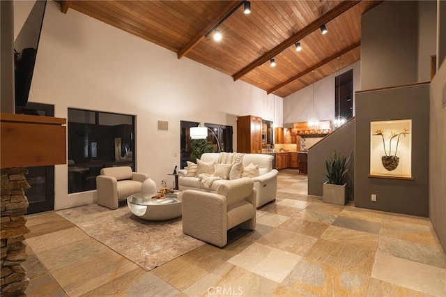 living room featuring high vaulted ceiling, beamed ceiling, track lighting, and wooden ceiling