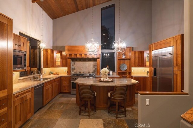 kitchen featuring an inviting chandelier, a kitchen island, high vaulted ceiling, and built in appliances