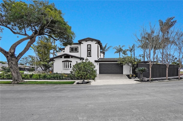 view of front facade featuring driveway, an attached garage, and stucco siding