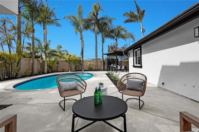 view of swimming pool with a fenced in pool, outdoor dining area, a patio area, and a fenced backyard