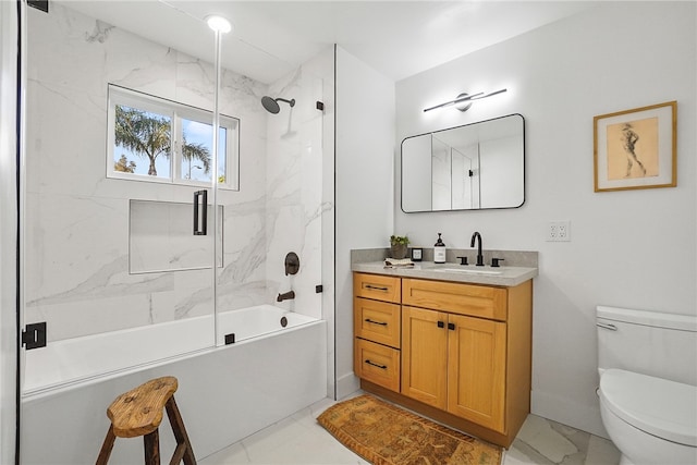 full bathroom featuring toilet, marble finish floor, shower / bath combination with glass door, and vanity