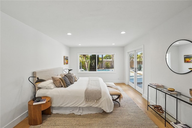 bedroom with baseboards, access to outside, light wood-style flooring, and recessed lighting