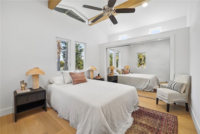 bedroom featuring vaulted ceiling, ceiling fan, light wood finished floors, and baseboards