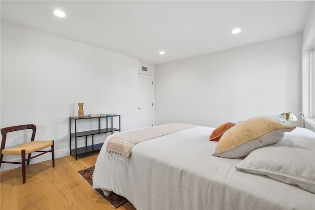 bedroom with light wood-type flooring, visible vents, baseboards, and recessed lighting