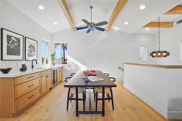 dining room featuring beverage cooler, baseboards, vaulted ceiling with beams, light wood-style floors, and recessed lighting