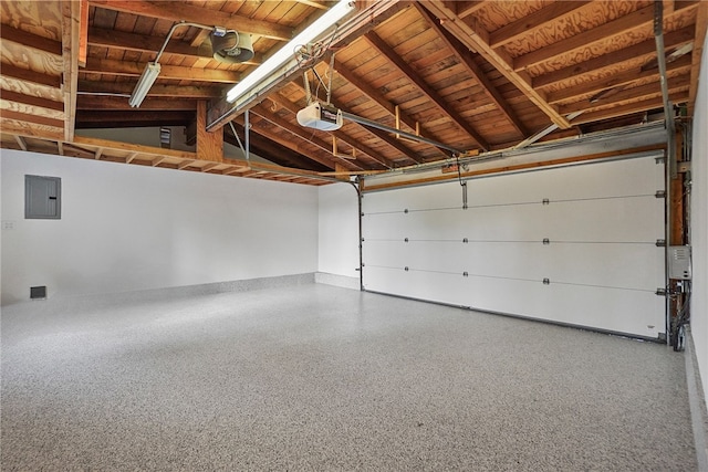 garage featuring a garage door opener, wooden ceiling, and electric panel