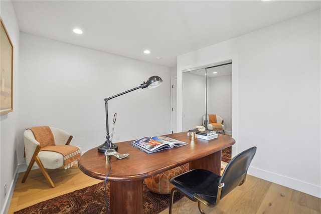 office area with baseboards, light wood-style flooring, and recessed lighting