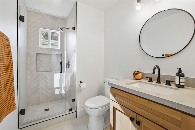 full bathroom featuring vanity, a shower stall, and toilet