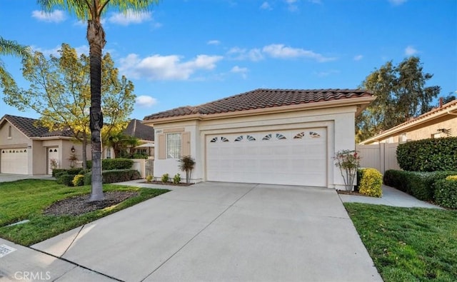 view of front of house featuring a garage and a front lawn