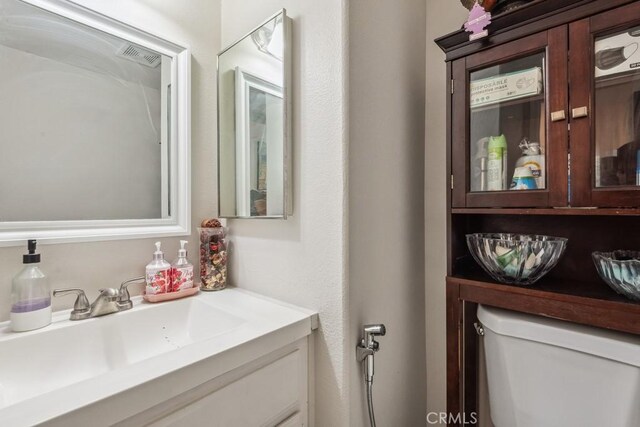 bathroom with toilet and vanity