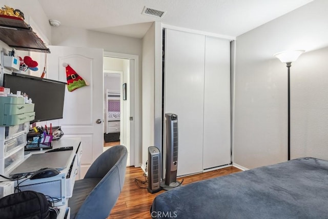 bedroom with hardwood / wood-style flooring