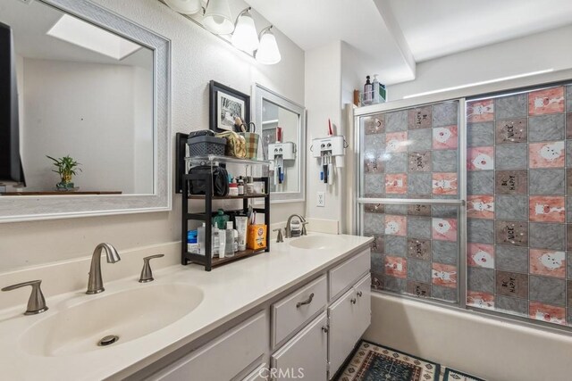 bathroom with enclosed tub / shower combo and vanity