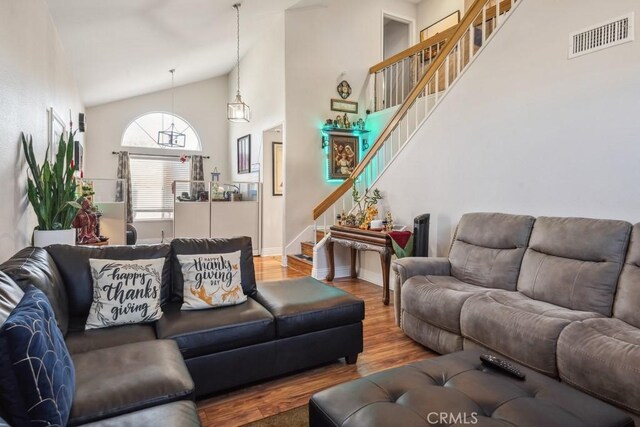 living room with vaulted ceiling and hardwood / wood-style flooring