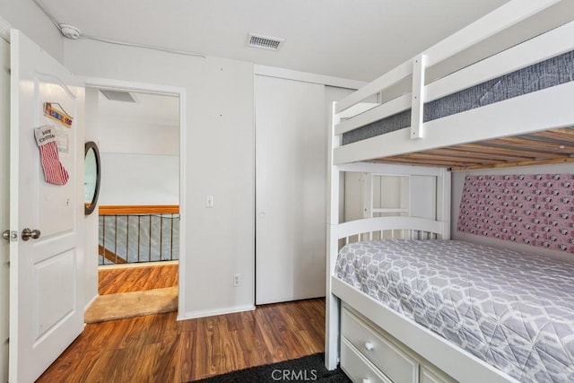 bedroom with a closet and dark hardwood / wood-style flooring