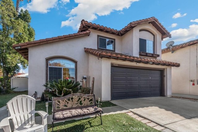 mediterranean / spanish house with a garage