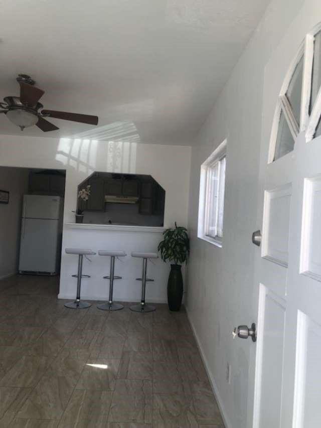 kitchen featuring ceiling fan and white refrigerator