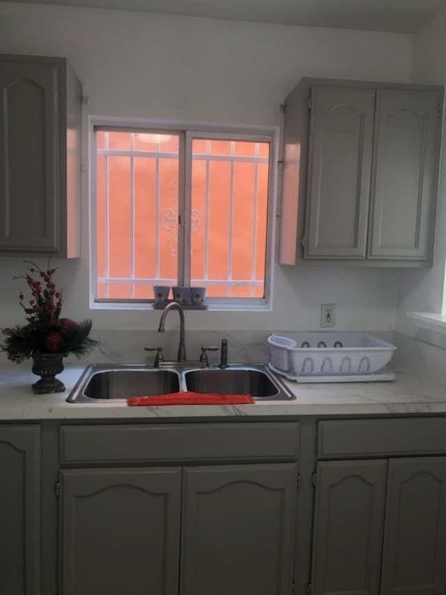 kitchen featuring gray cabinets and sink