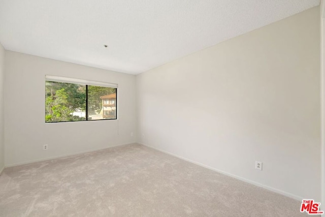 empty room featuring light colored carpet