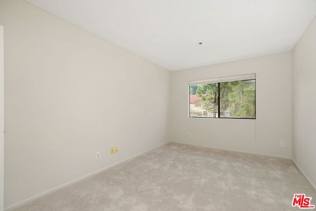 empty room featuring light colored carpet