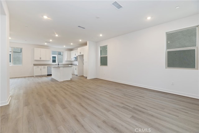 unfurnished living room with light hardwood / wood-style flooring