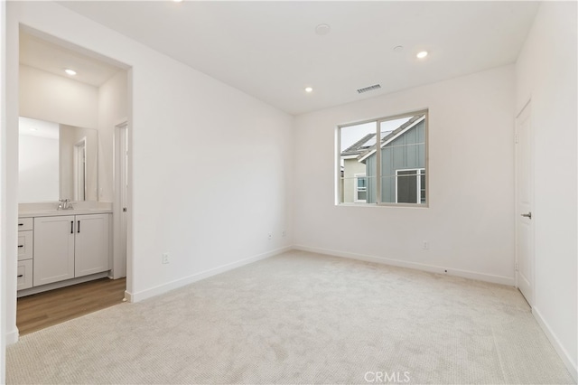 carpeted spare room featuring sink