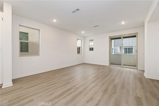 spare room with light hardwood / wood-style flooring