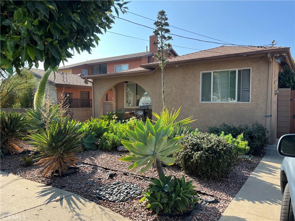 1547 Island Ave, Wilmington, CA 90744 - view of front of property featuring stucco siding and a chimney