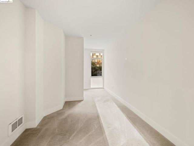 hallway with light colored carpet