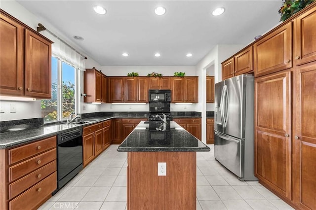 kitchen with sink, black appliances, dark stone countertops, a kitchen island, and light tile patterned flooring