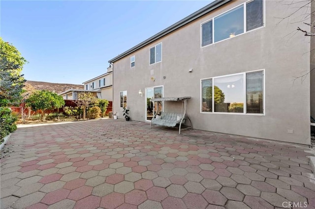 rear view of property featuring a patio