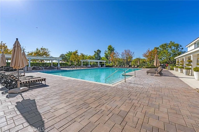 view of swimming pool featuring a pergola and a patio area