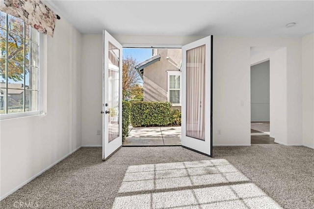 interior space with carpet floors and french doors