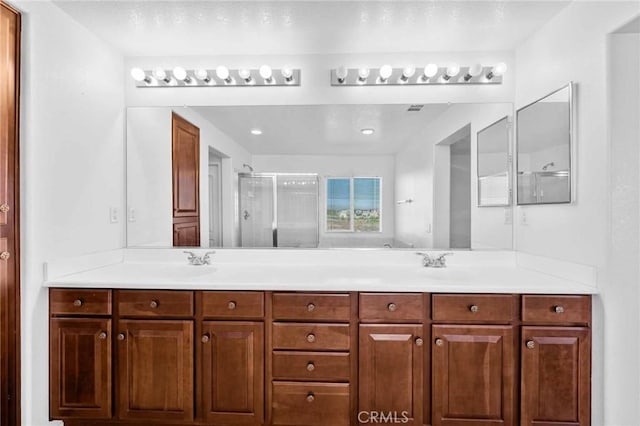 bathroom featuring vanity and an enclosed shower