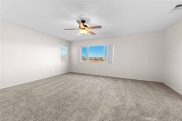 unfurnished room with carpet flooring and ceiling fan