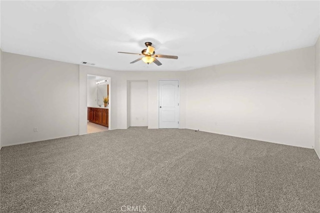 unfurnished bedroom with connected bathroom, ceiling fan, and light colored carpet