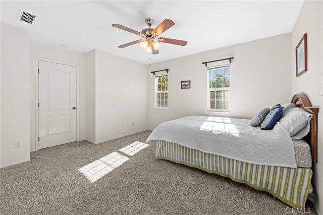 bedroom featuring ceiling fan and carpet