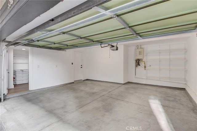 garage featuring a garage door opener and water heater