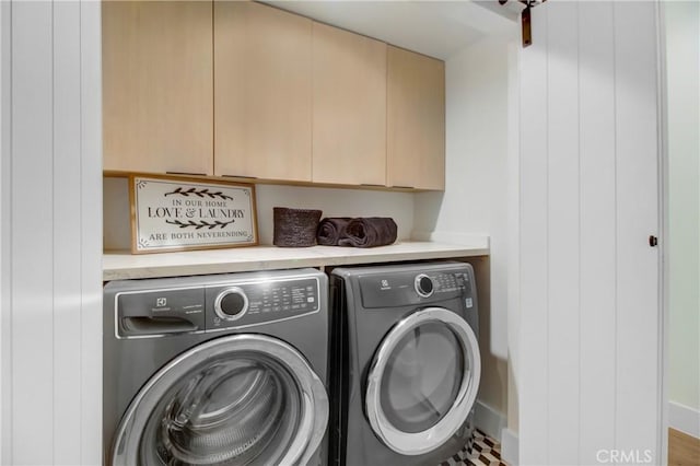 laundry room with cabinets and separate washer and dryer