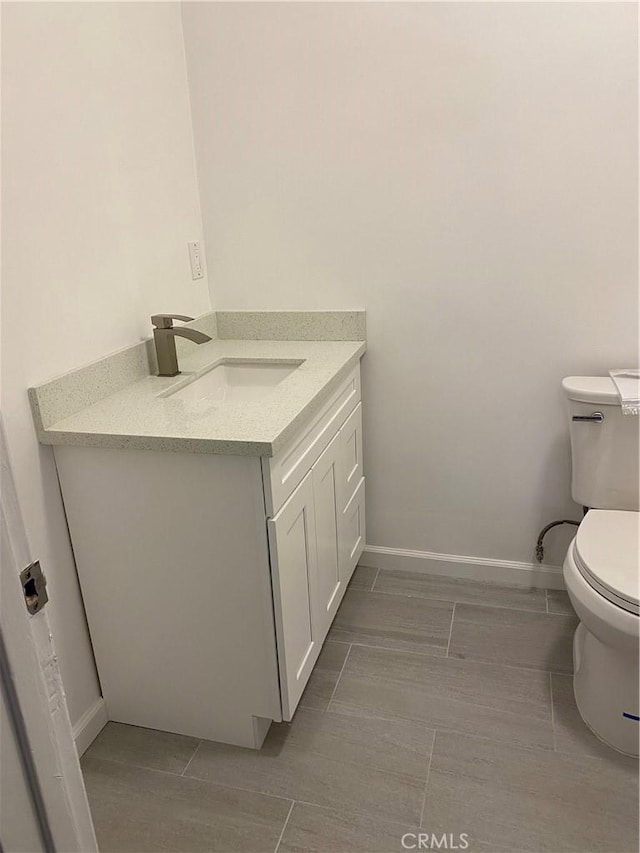 bathroom featuring tile patterned floors, toilet, and vanity