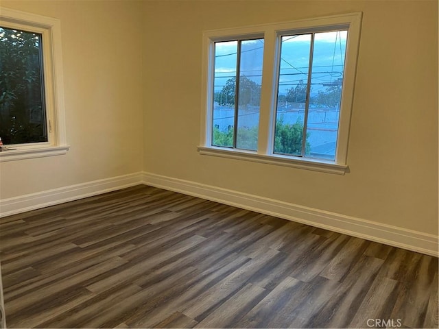 spare room featuring dark hardwood / wood-style flooring