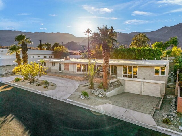 back of property featuring a mountain view and a garage