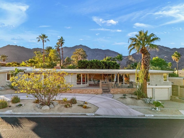 single story home featuring a garage and a mountain view