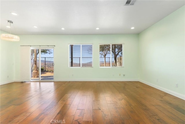 spare room with hardwood / wood-style floors