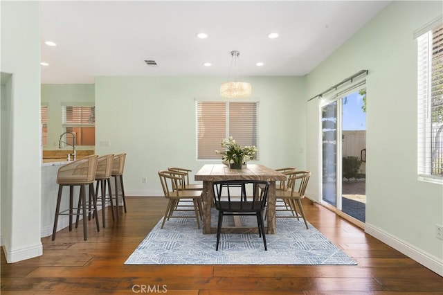 dining space with sink and dark hardwood / wood-style flooring