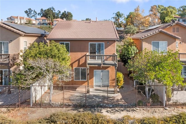 rear view of property with a balcony