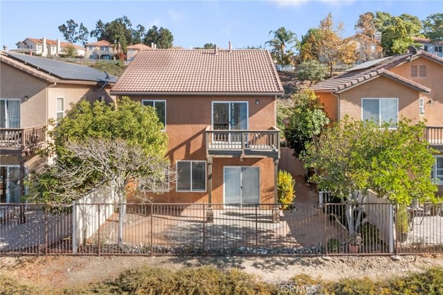 rear view of property featuring a balcony