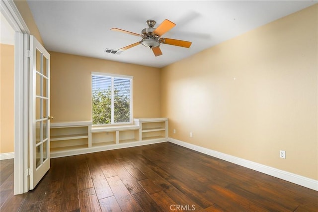 empty room featuring ceiling fan and dark hardwood / wood-style flooring